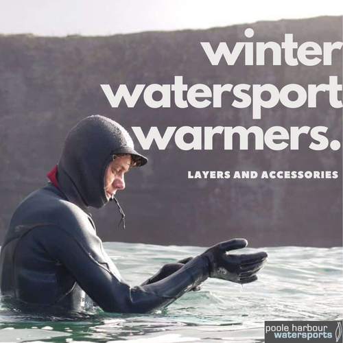 Person in winter wetsuit and gloves preparing for cold water watersports outdoors